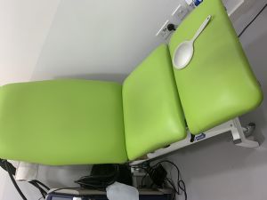 treatment couch with gynaecological stirrups